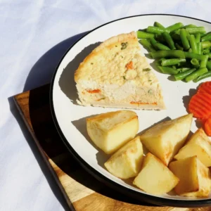 Spinach quiche with roast potatoes, carrots, beans