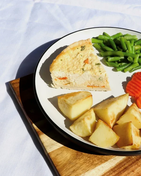 Spinach quiche with roast potatoes, carrots, beans