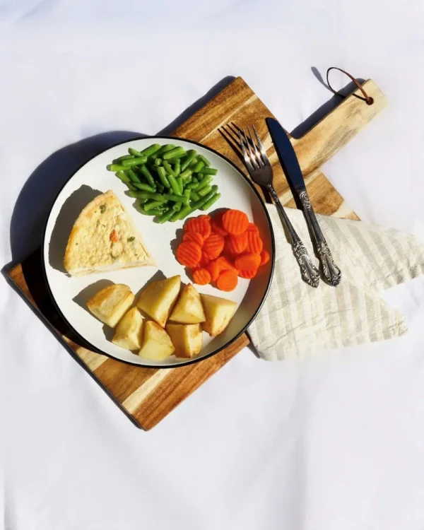 Spinach quiche with roast potatoes, carrots, beans