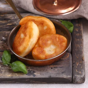 Three pieces of piroshki, potato filled crispy hand pies