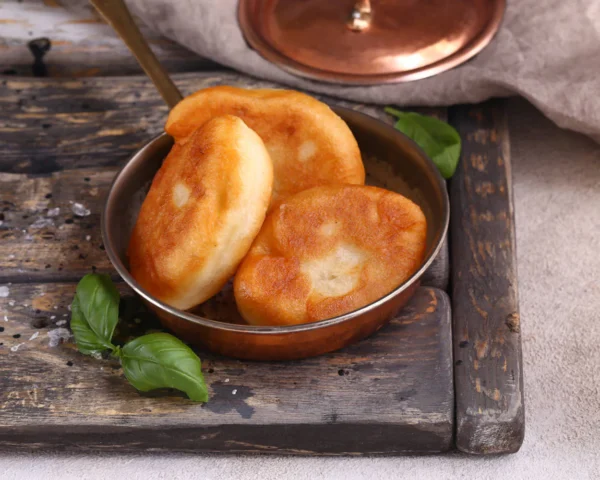 Three pieces of piroshki, potato filled crispy hand pies